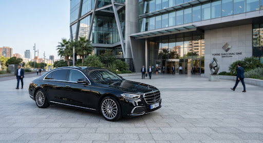 Executive sedan outside corporate building